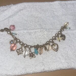 Gold and Pink Charm Bracelet with Intricate Details